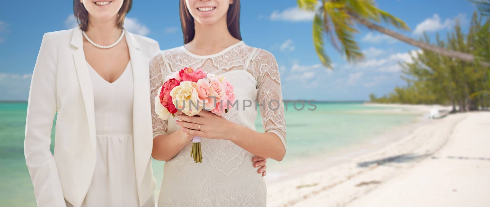 close up of happy lesbian couple with flowers by dolgachov