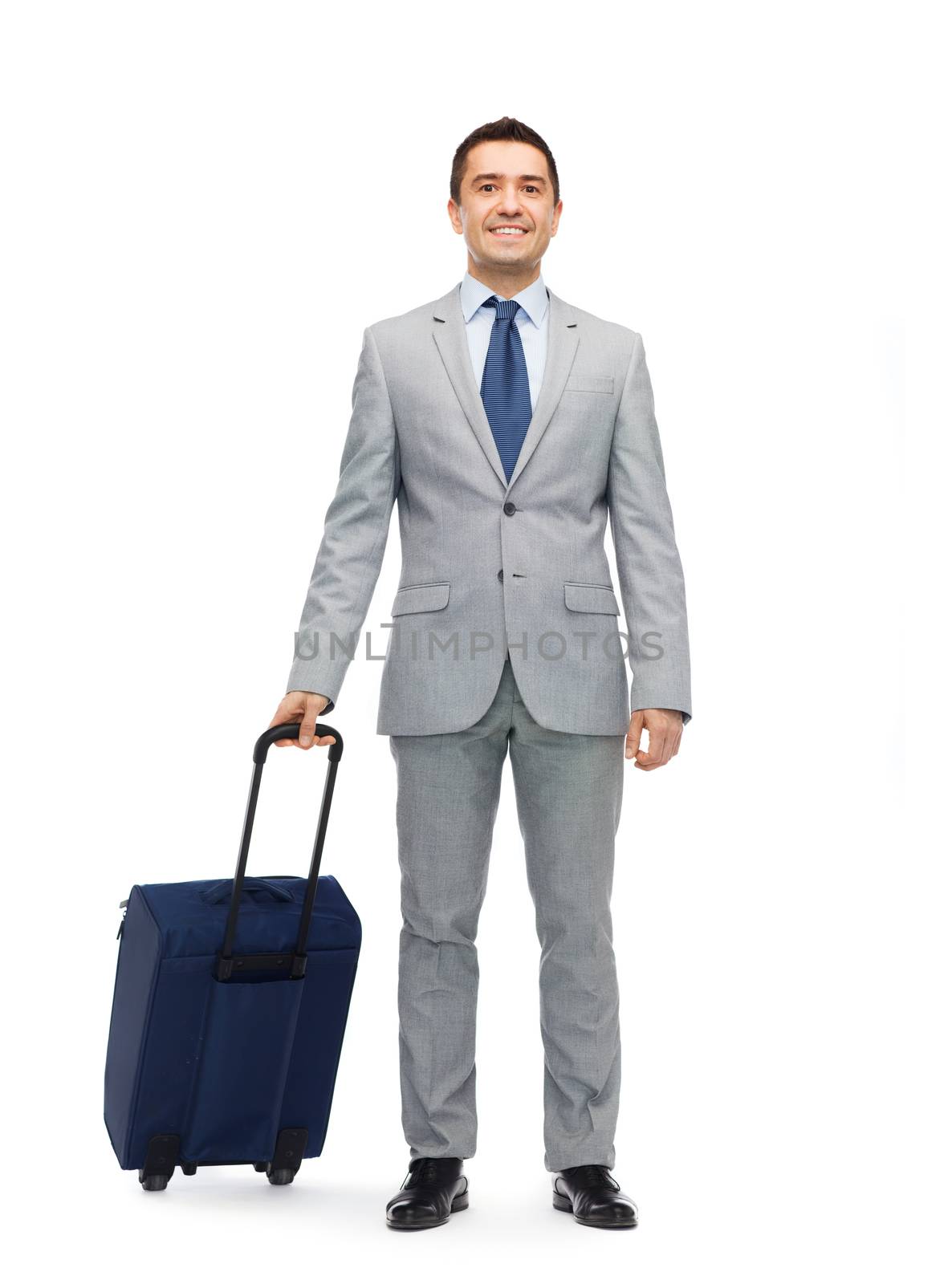 happy businessman in suit with travel bag by dolgachov