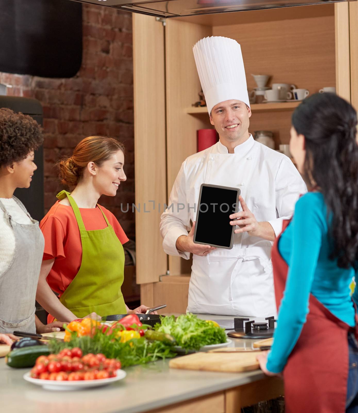 happy women with chef and tablet pc in kitchen by dolgachov