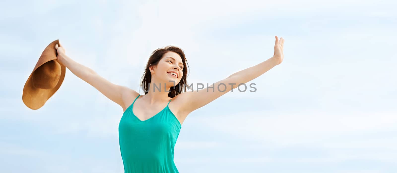 summer holidays and vacation concept - girl in hat standing on the beach