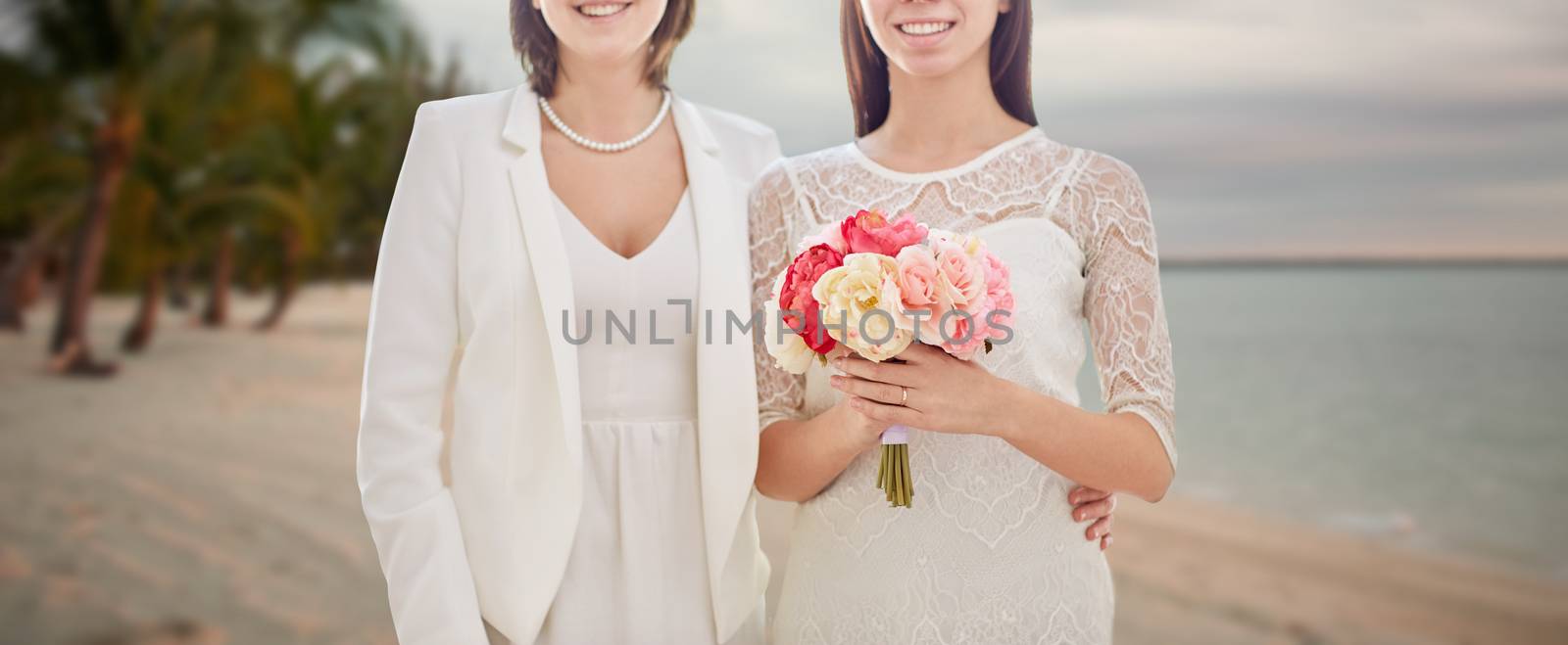 close up of happy lesbian couple with flowers by dolgachov