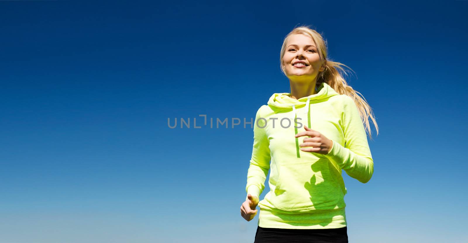 woman jogging outdoors by dolgachov
