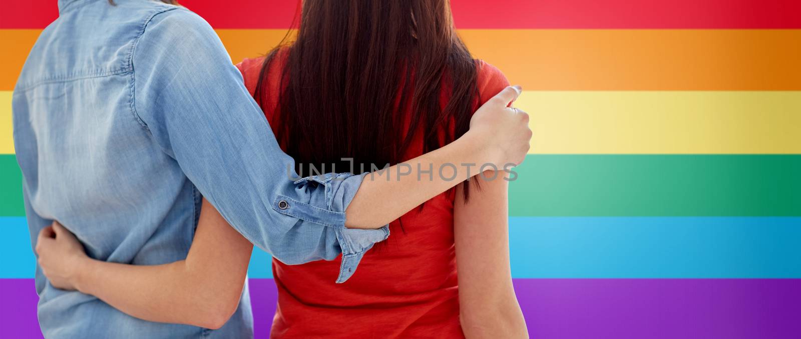 close up of happy lesbian couple hugging at home by dolgachov