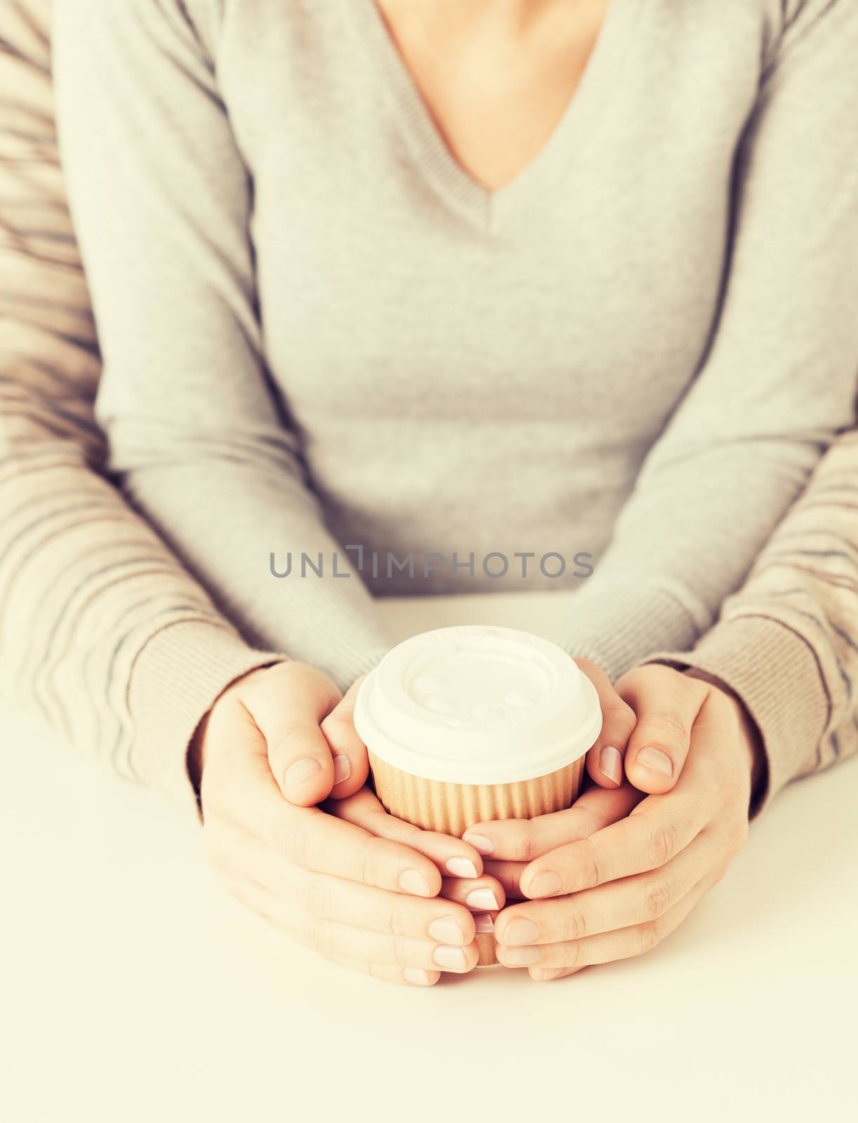 woman and man hands holding take away coffee cup