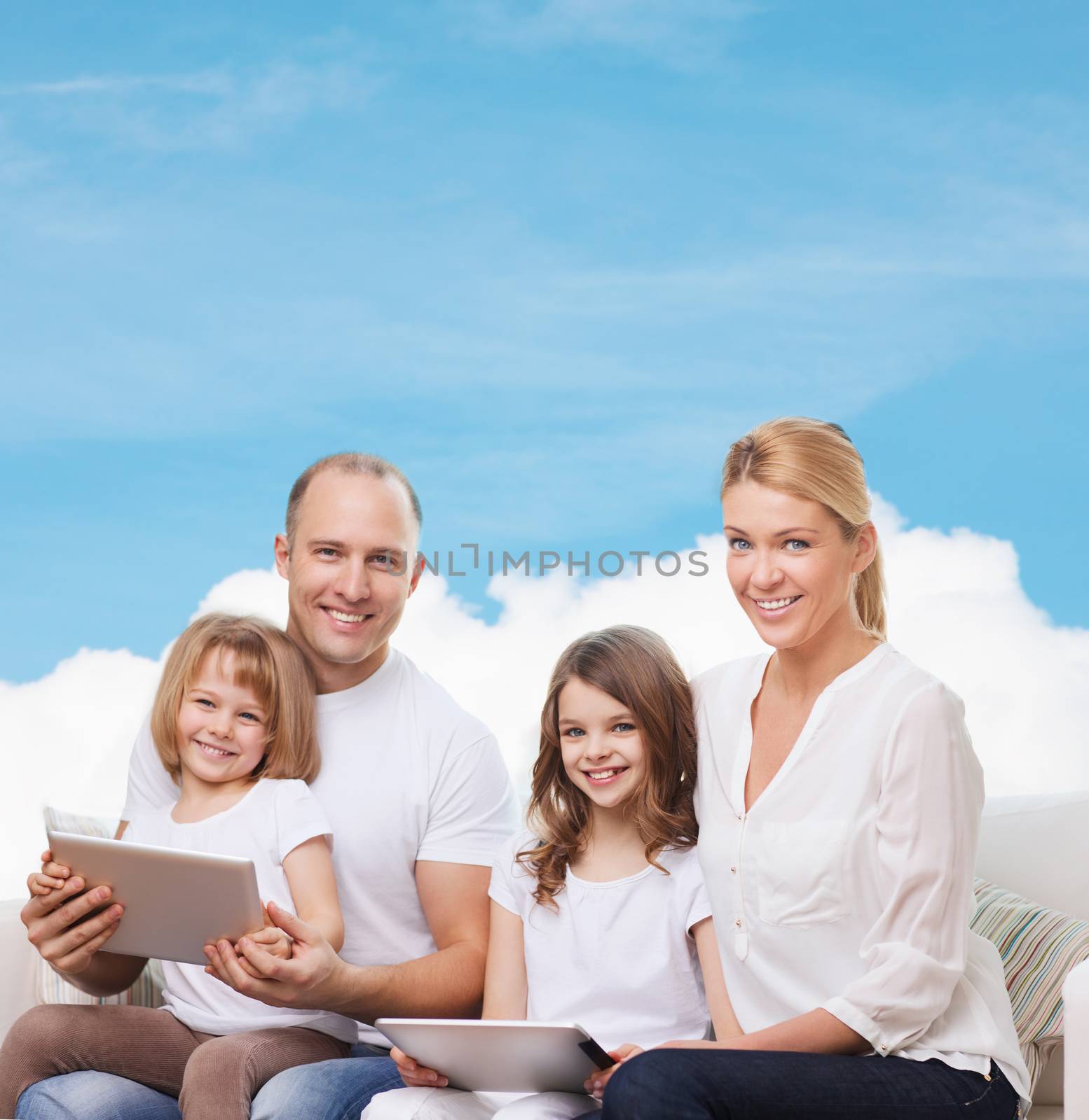 family, technology and people - smiling mother, father and little girls with tablet pc computers over blue sky and white cloud background