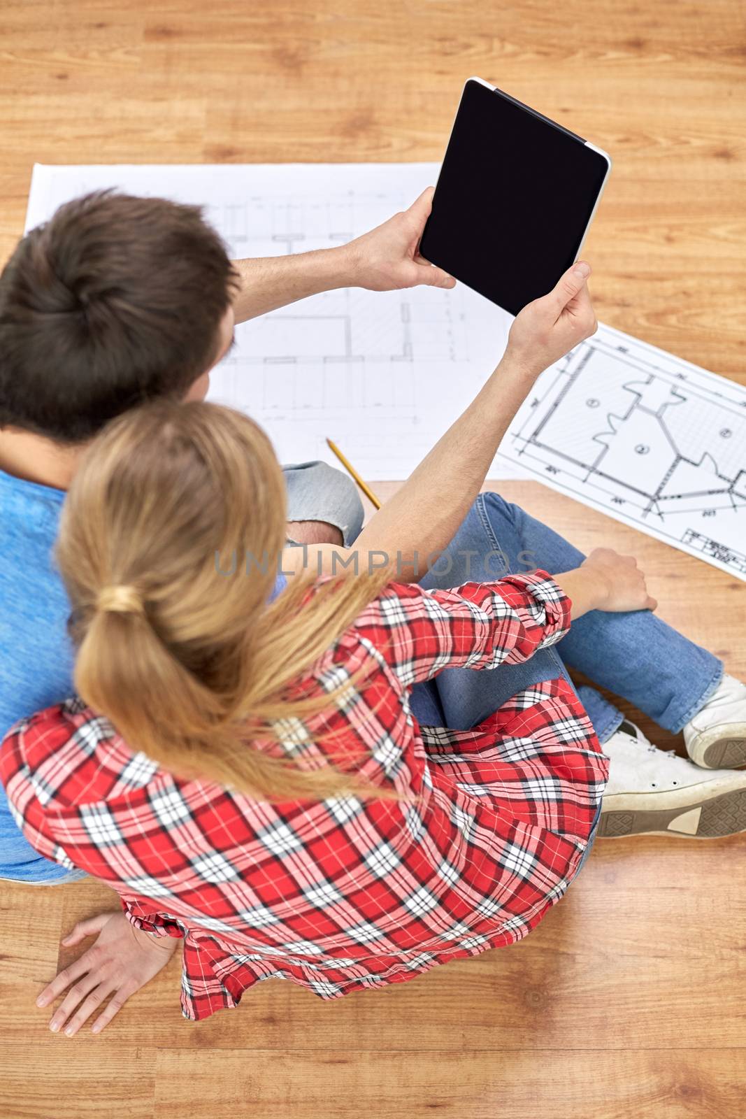 close up of couple with tablet pc and blueprints by dolgachov