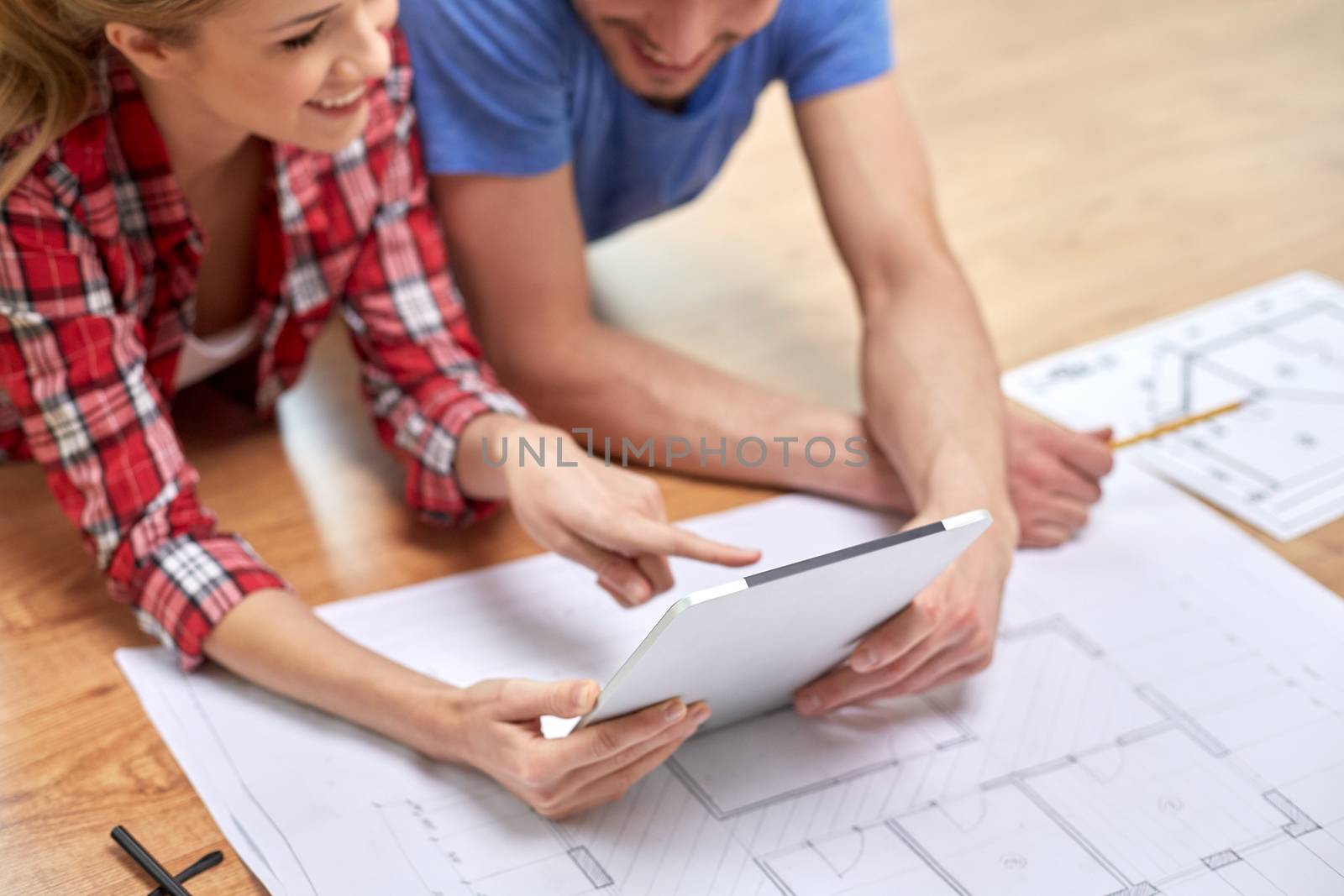 close up of couple with tablet pc and blueprint by dolgachov