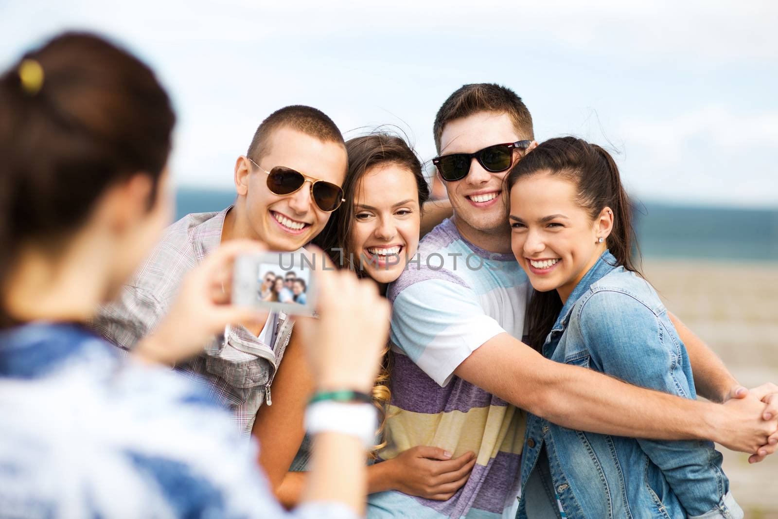 teenagers taking photo outside by dolgachov