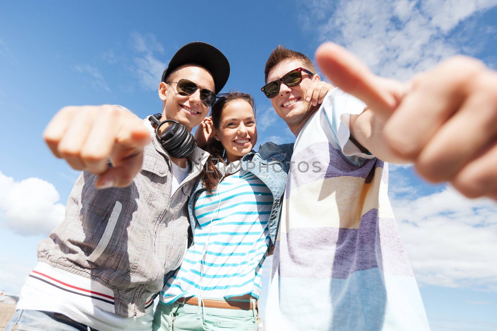 summer holidays and teenage concept - group of teenagers outside