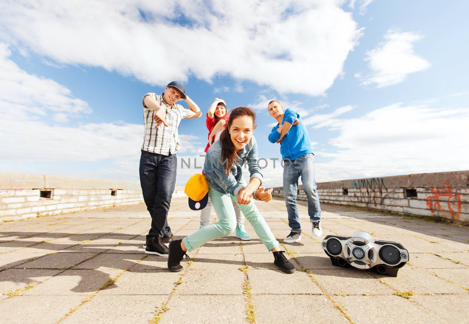 group of teenagers dancing by dolgachov