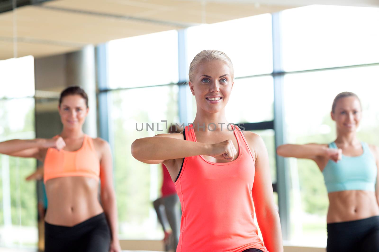 group of women working out in gym by dolgachov