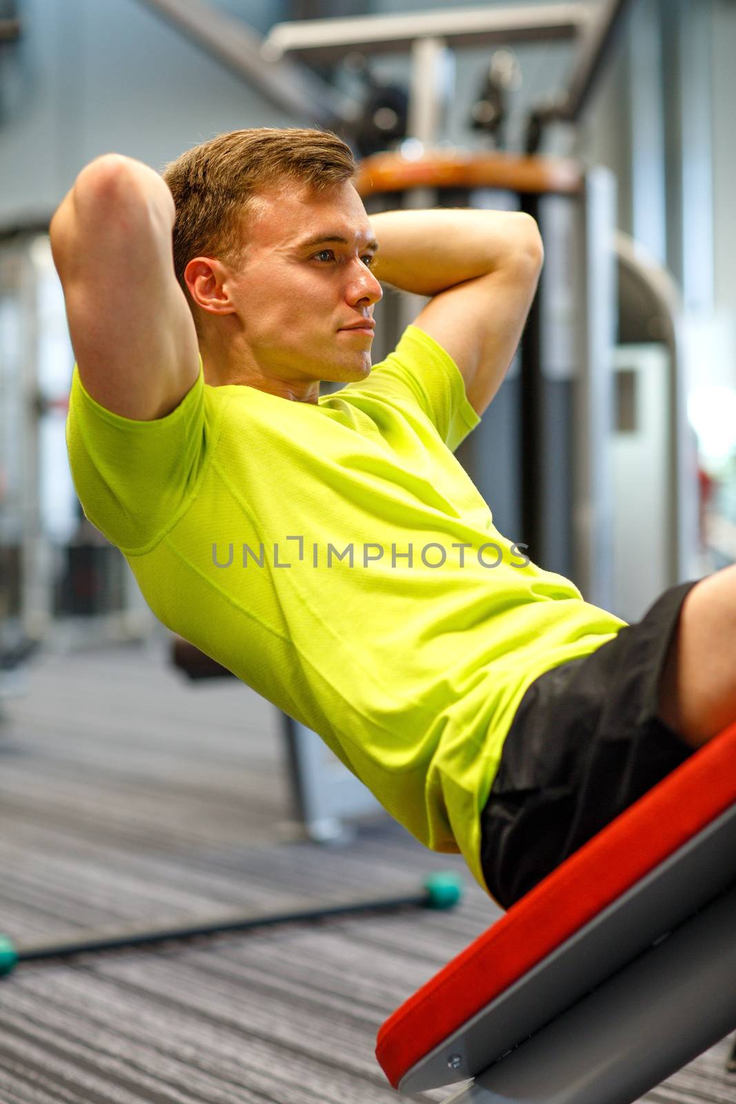 sport, fitness, lifestyle and people concept - man exercising in gym