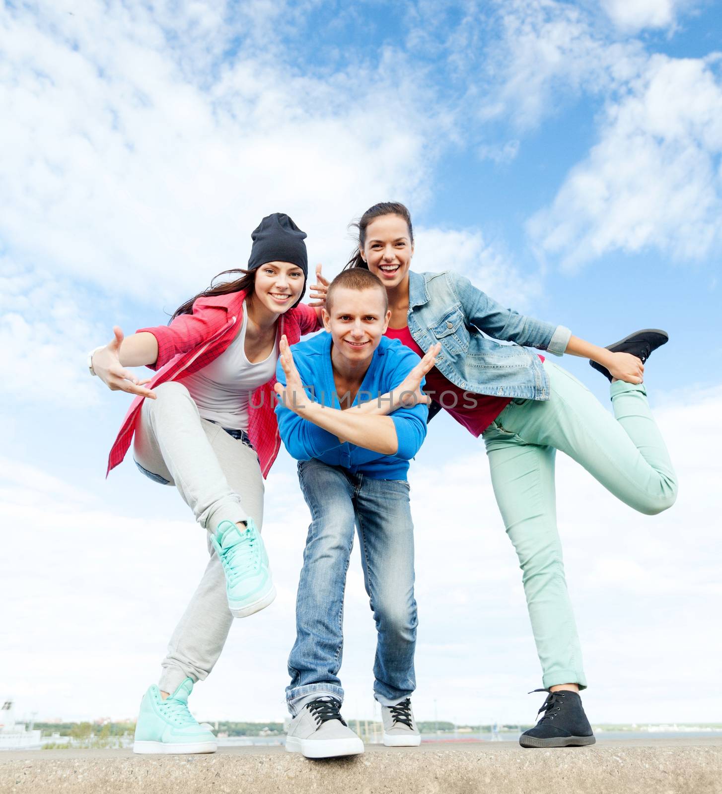 sport, dancing and urban culture concept - group of teenagers dancing