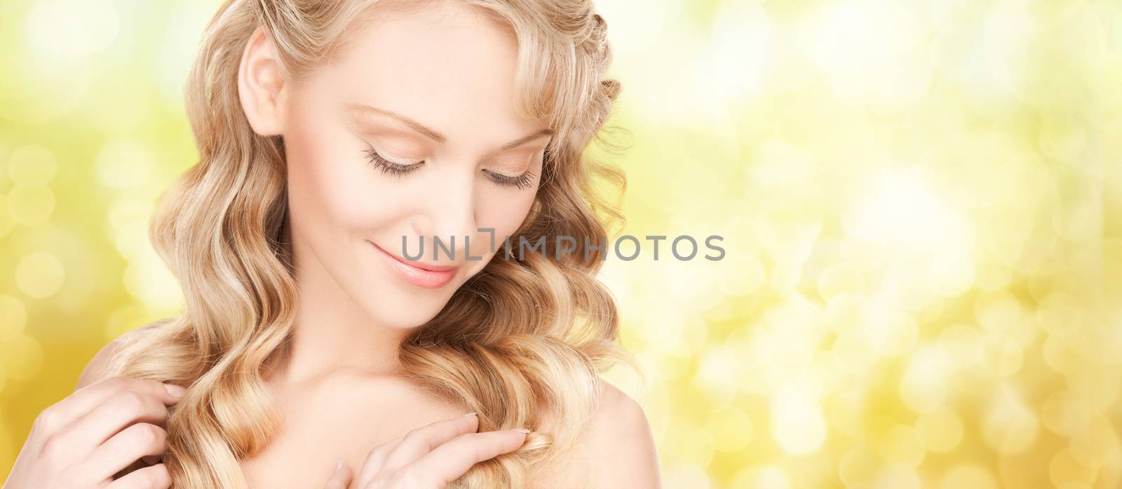 beautiful young woman face with long wavy hair by dolgachov