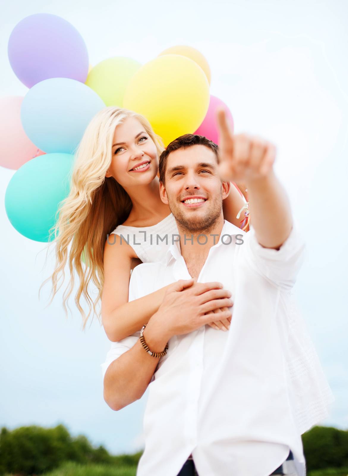 couple with colorful balloons at sea side by dolgachov