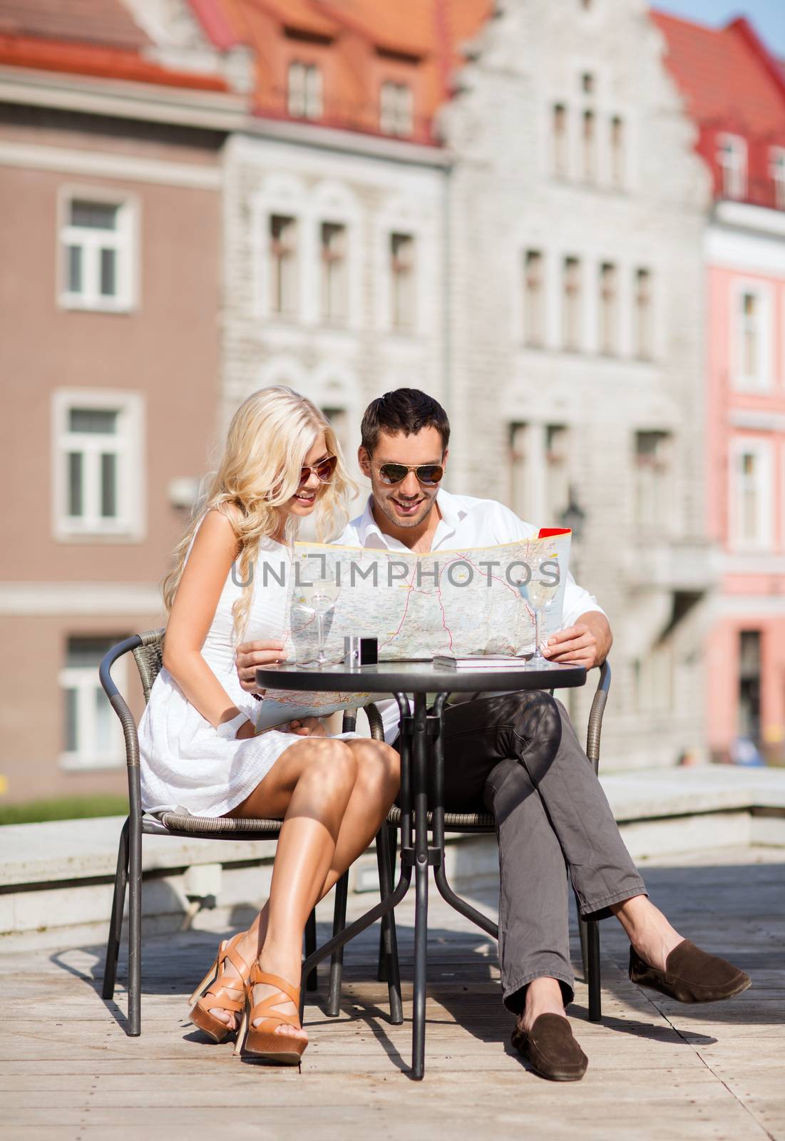 summer holidays, dating and tourism concept - couple with map in cafe in the city