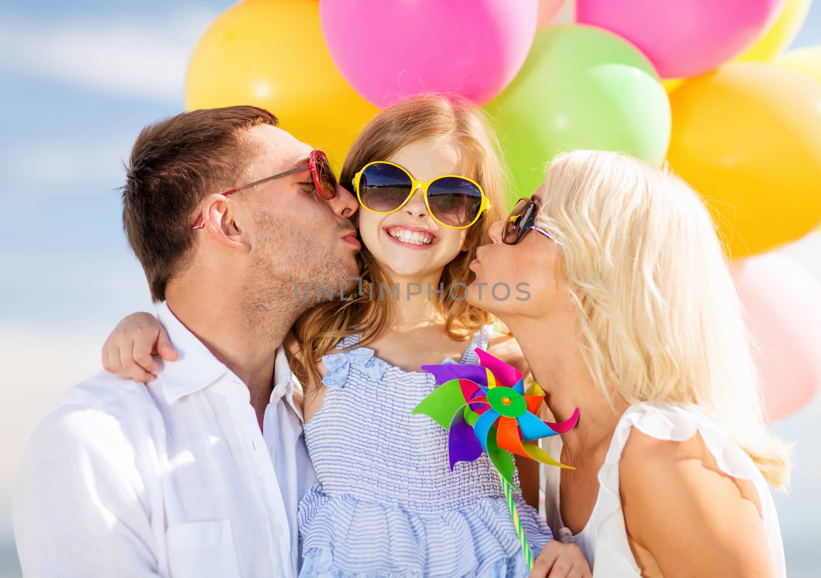 summer holidays, celebration, children and people concept - family with colorful balloons