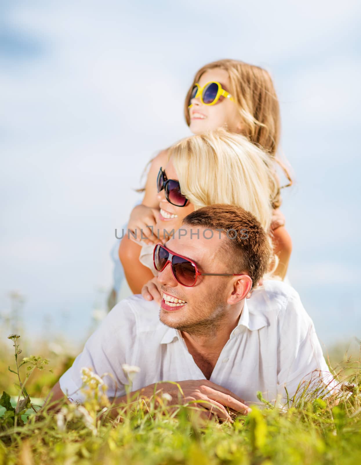 happy family with blue sky and green grass by dolgachov