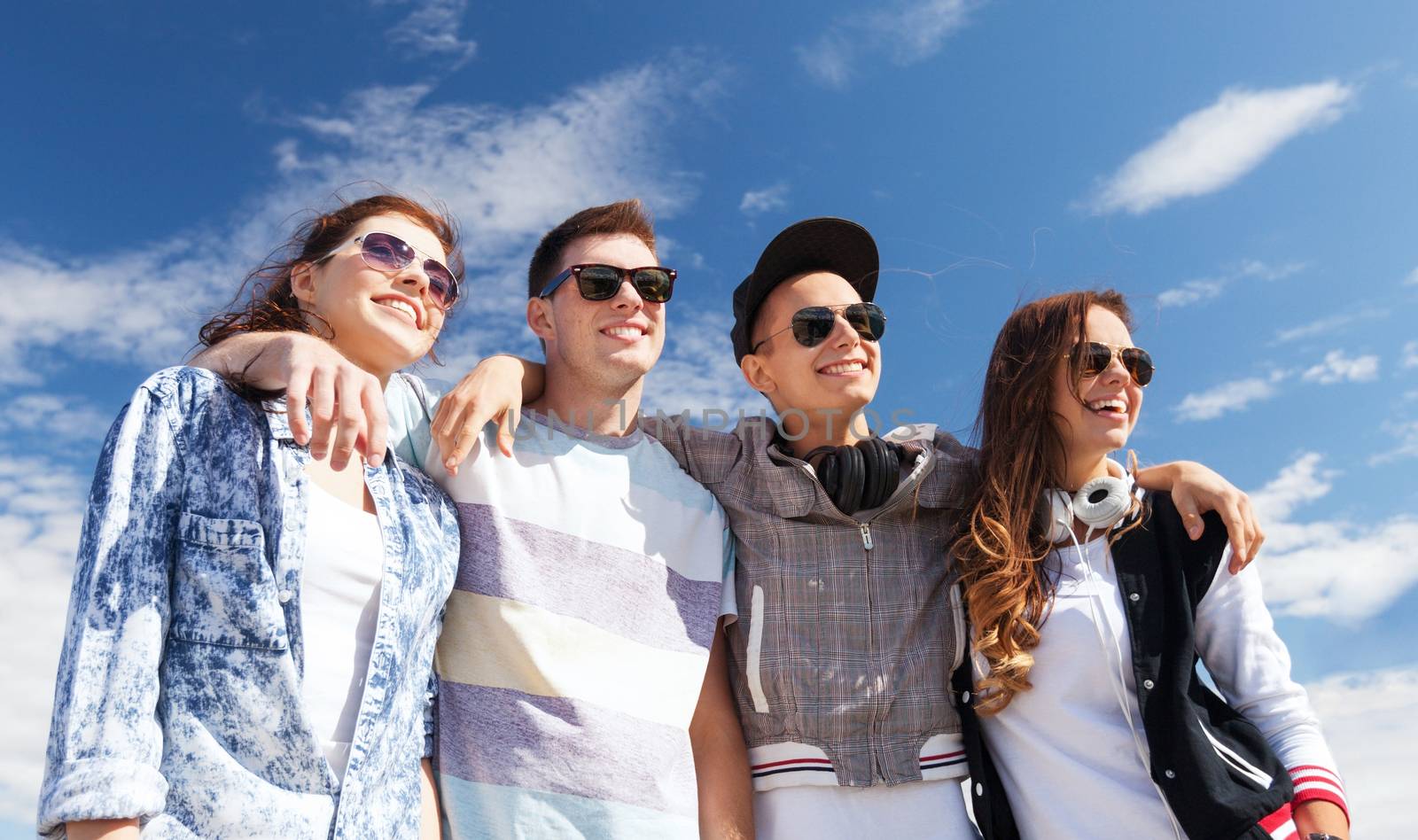 summer holidays and teenage concept - group of teenagers outside