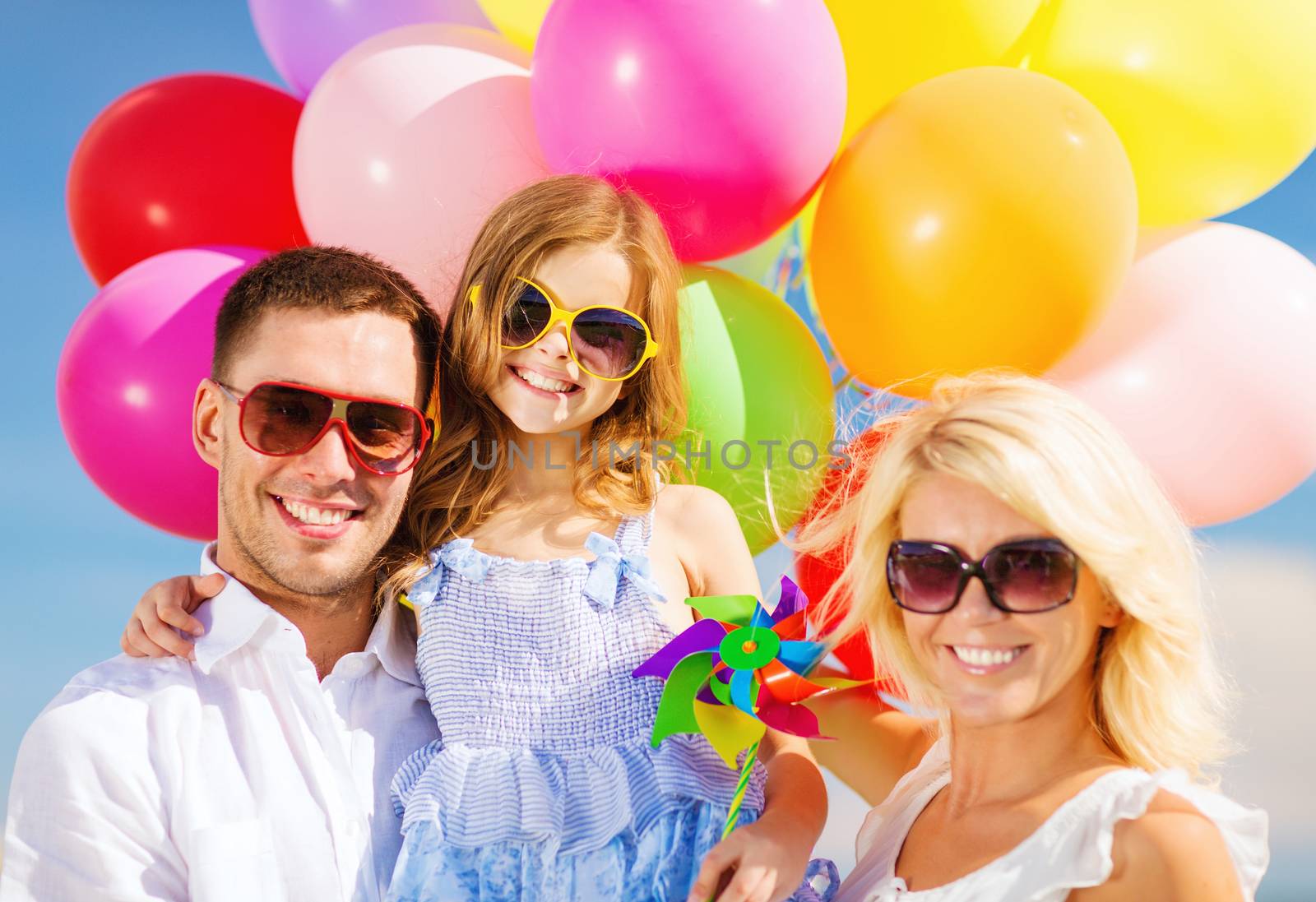 summer holidays, celebration, children and people concept - family with colorful balloons