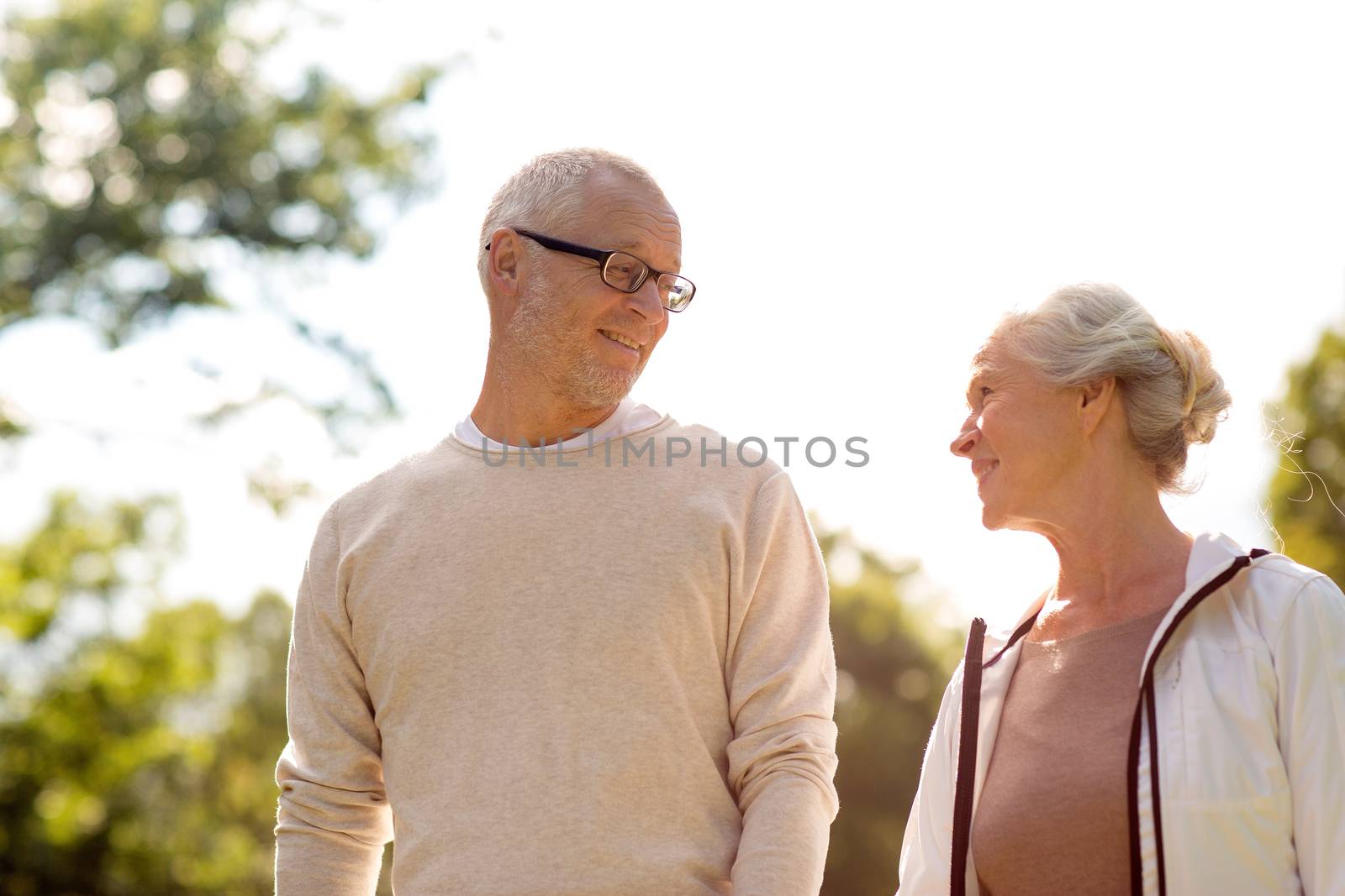 family, age, tourism, travel and people concept - senior couple in park