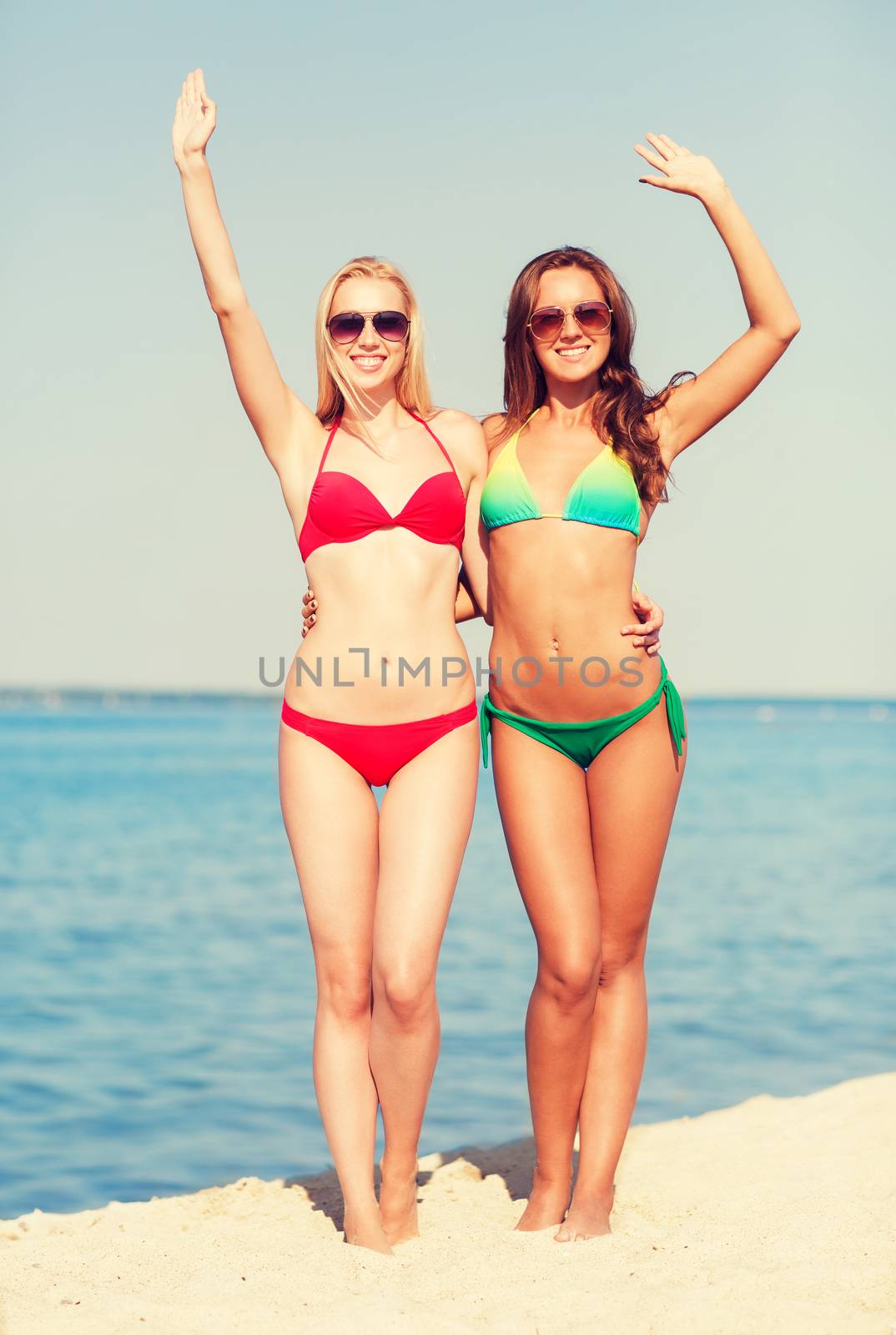 two smiling young women on beach by dolgachov