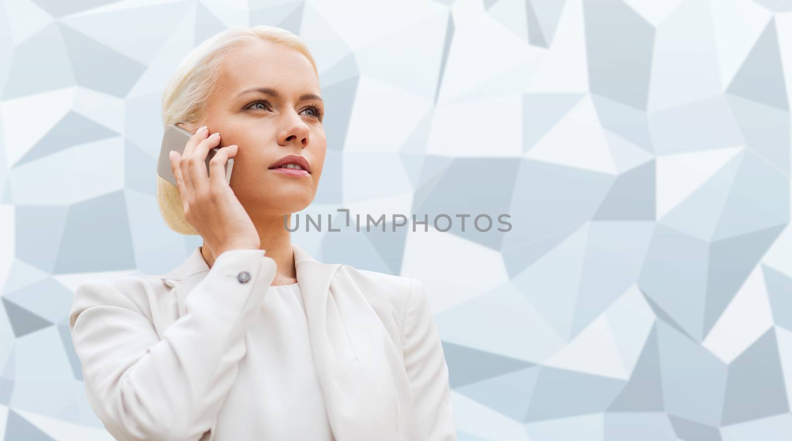 business, technology and people concept - serious businesswoman with smartphone talking over gray graphic low poly background