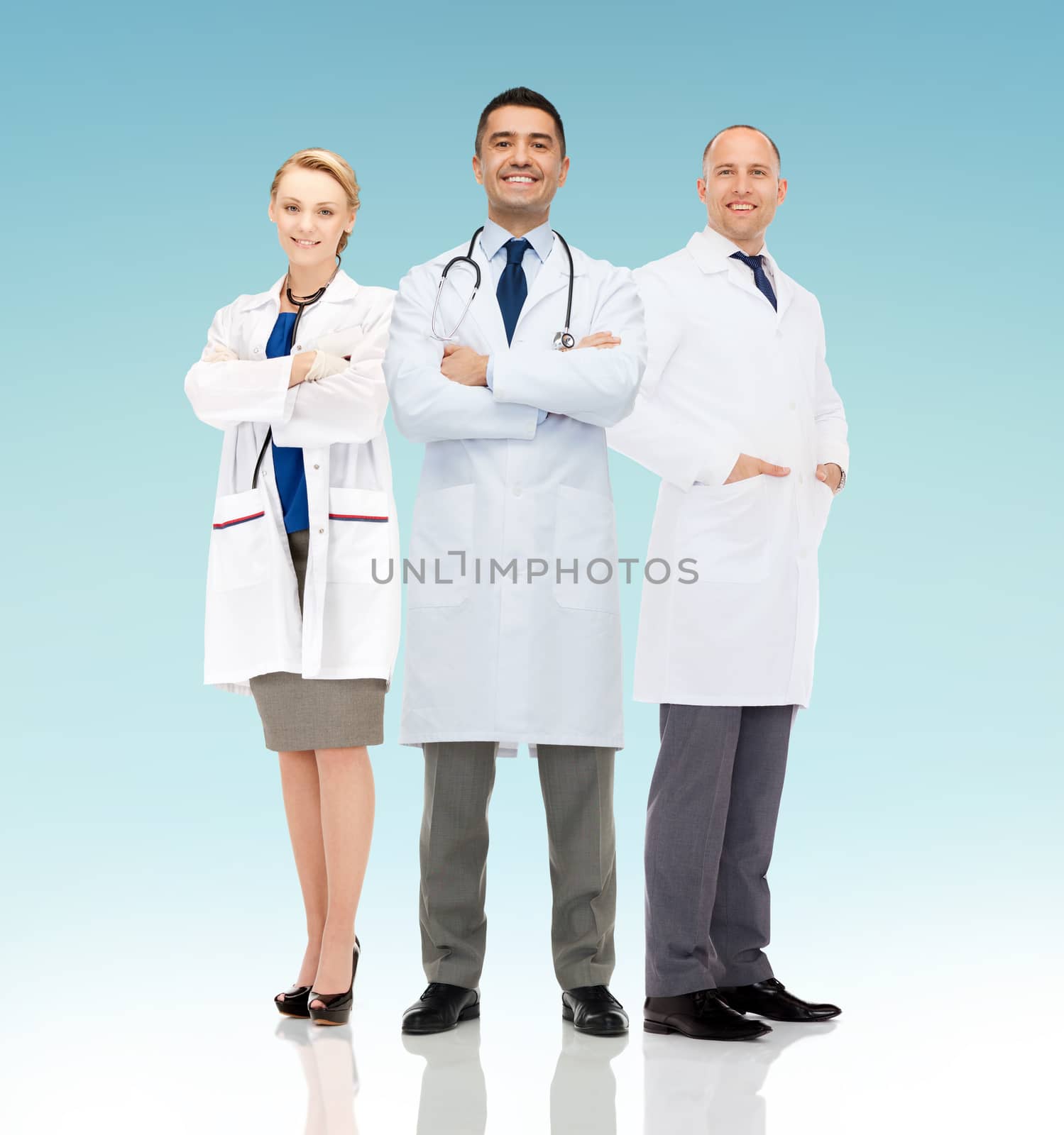 healthcare, advertisement, people and medicine concept - group of smiling doctors in white coats over blue background