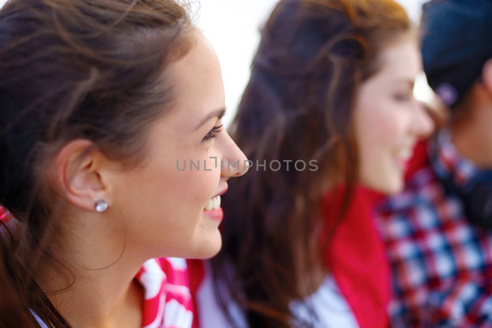 summer holidays, people and happiness concept - smiling teenage girl outdoors with friends