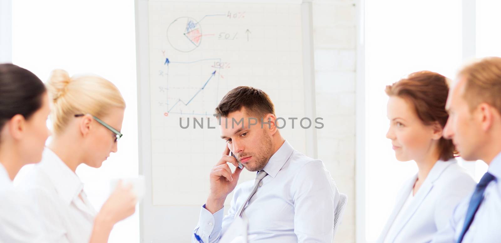 stressed male boss on business meeting with team in office