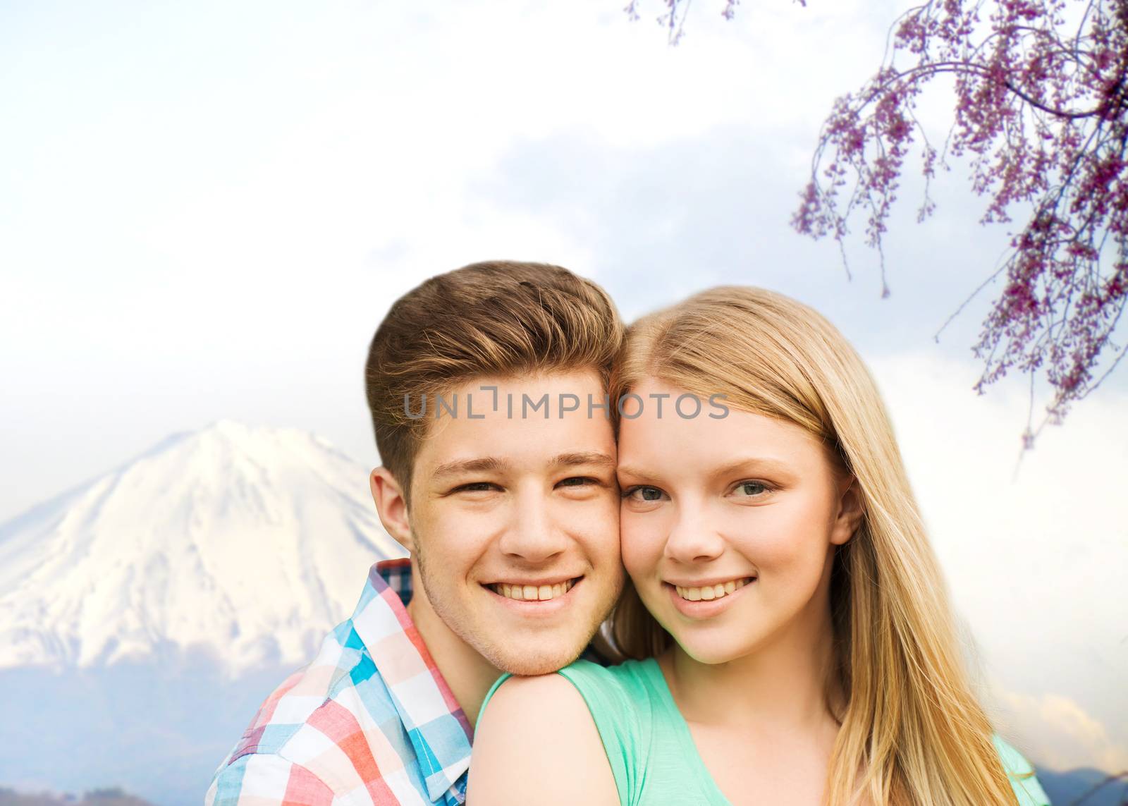 smiling couple hugging over mountains background by dolgachov