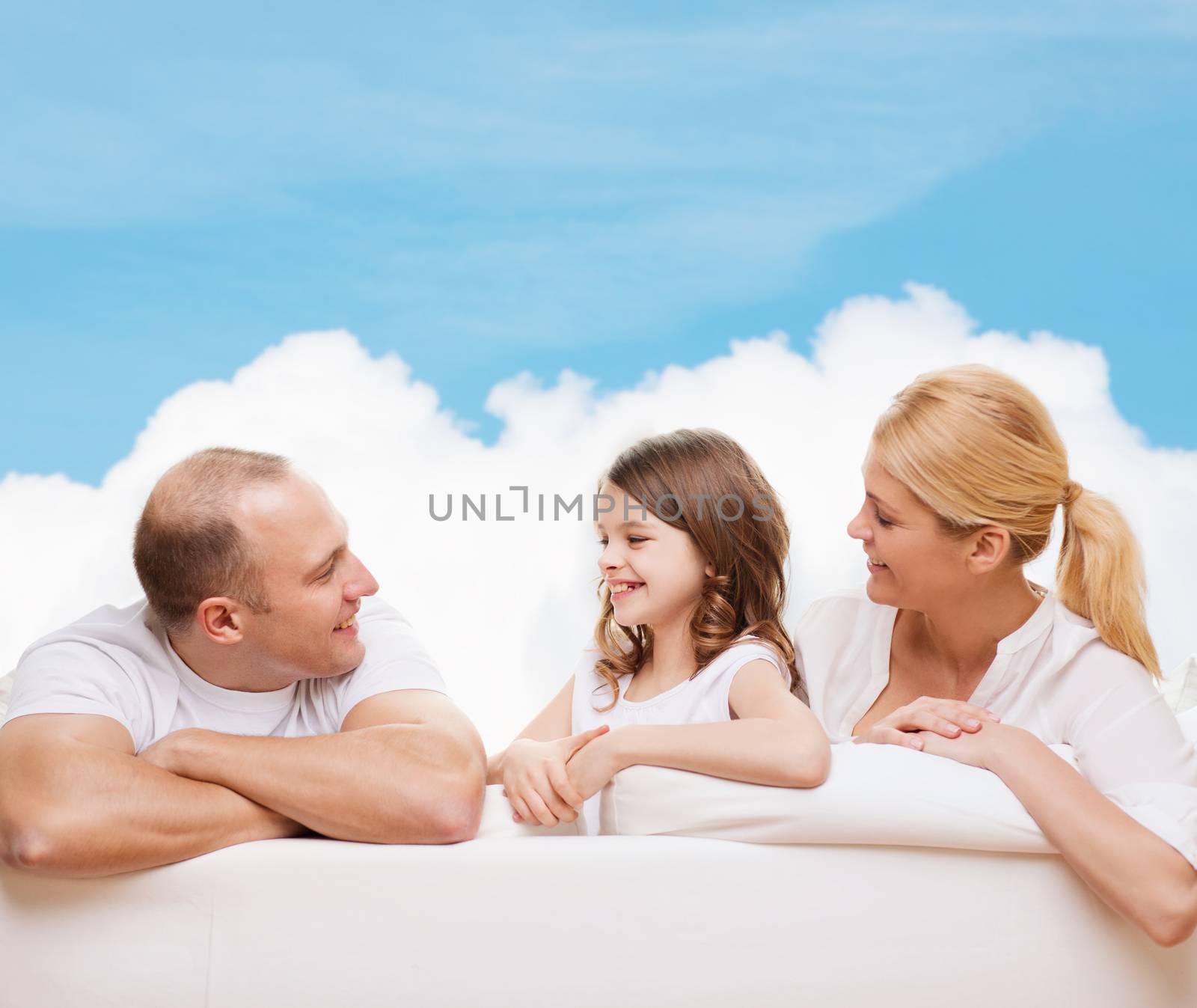 family, childhood and people - smiling mother, father and little girl over blue sky and white cloud background