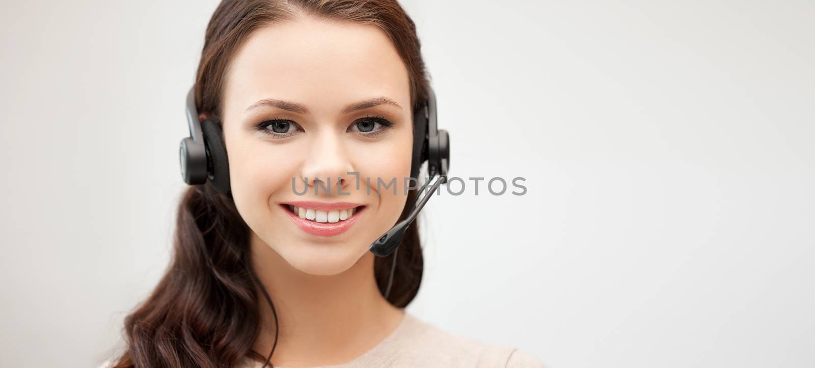 friendly female helpline operator with headphones by dolgachov