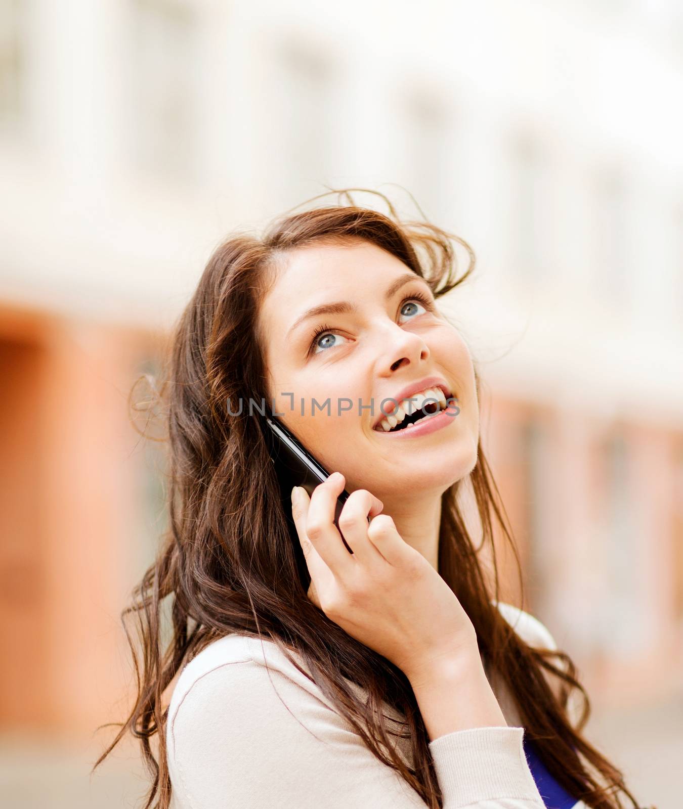 young woman talking on the phone outdoors