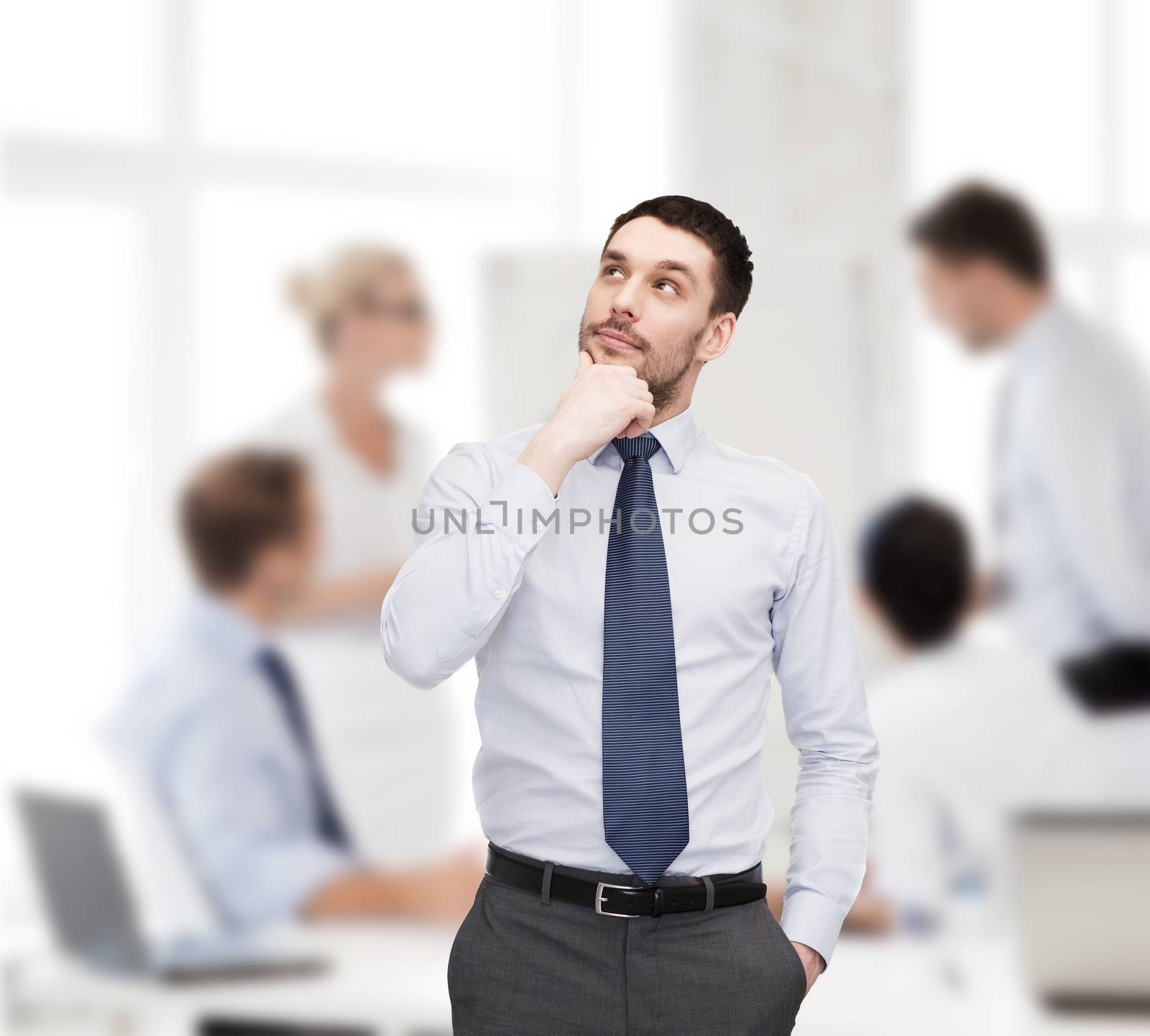 business and office concept - handsome businessman looking up