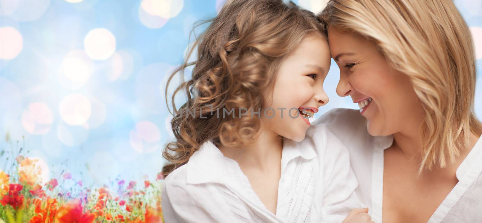 people, family, love and harmony concept - happy mother and daughter cuddling over blue sky and poppy field n background