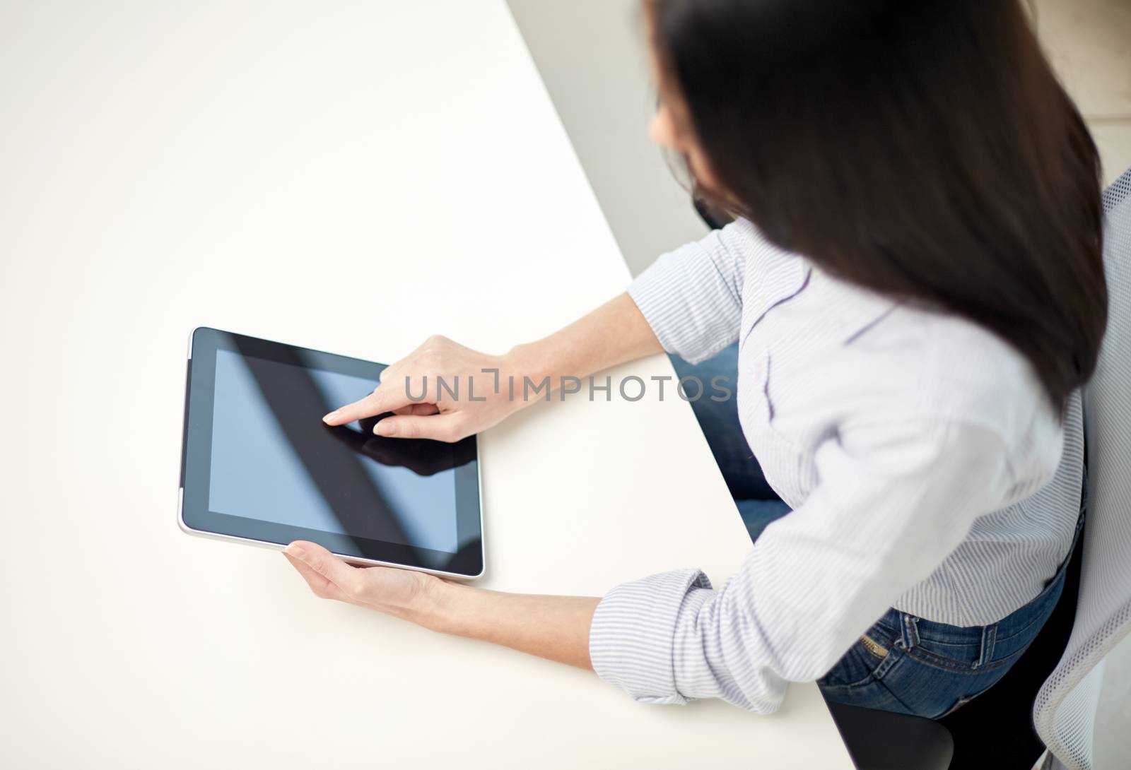 business, technology, communication and people concept - close up of woman with tablet pc computer at office or home