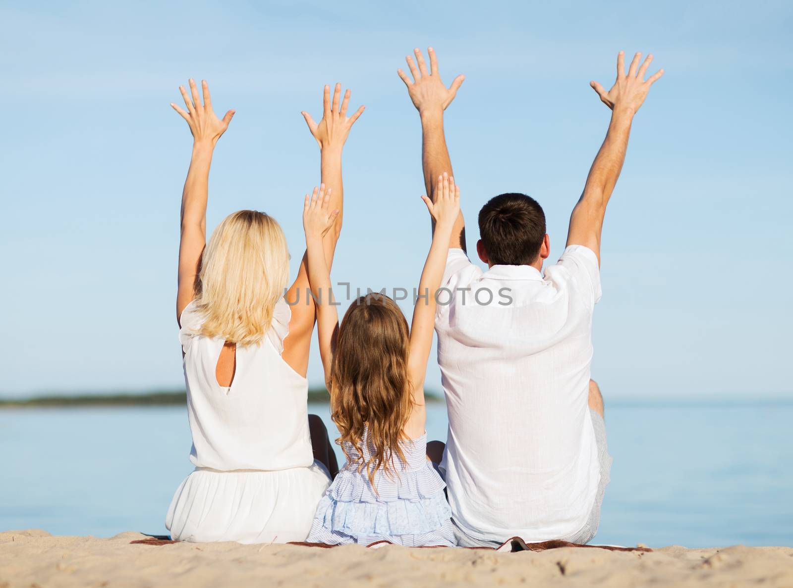 summer holidays, celebration, children and people concept - happy family at the seaside with greeting gesture