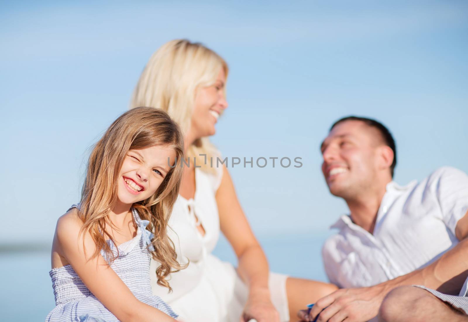 happy family having a picnic by dolgachov