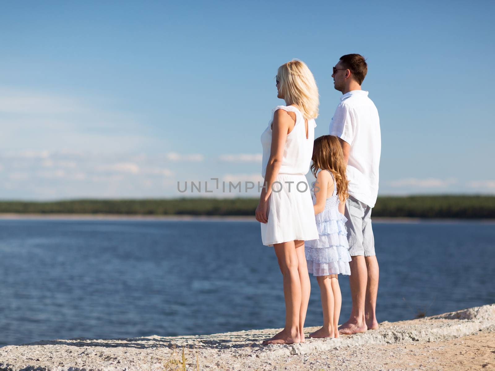 summer holidays, celebration, children and people concept - happy family at the seaside