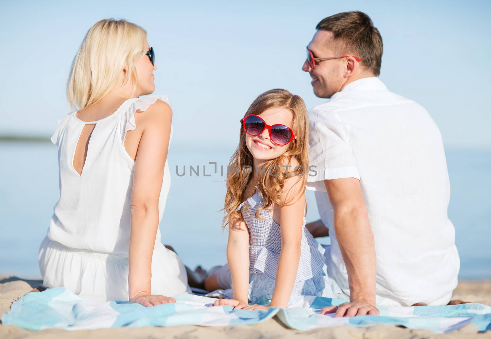 happy family on the beach by dolgachov