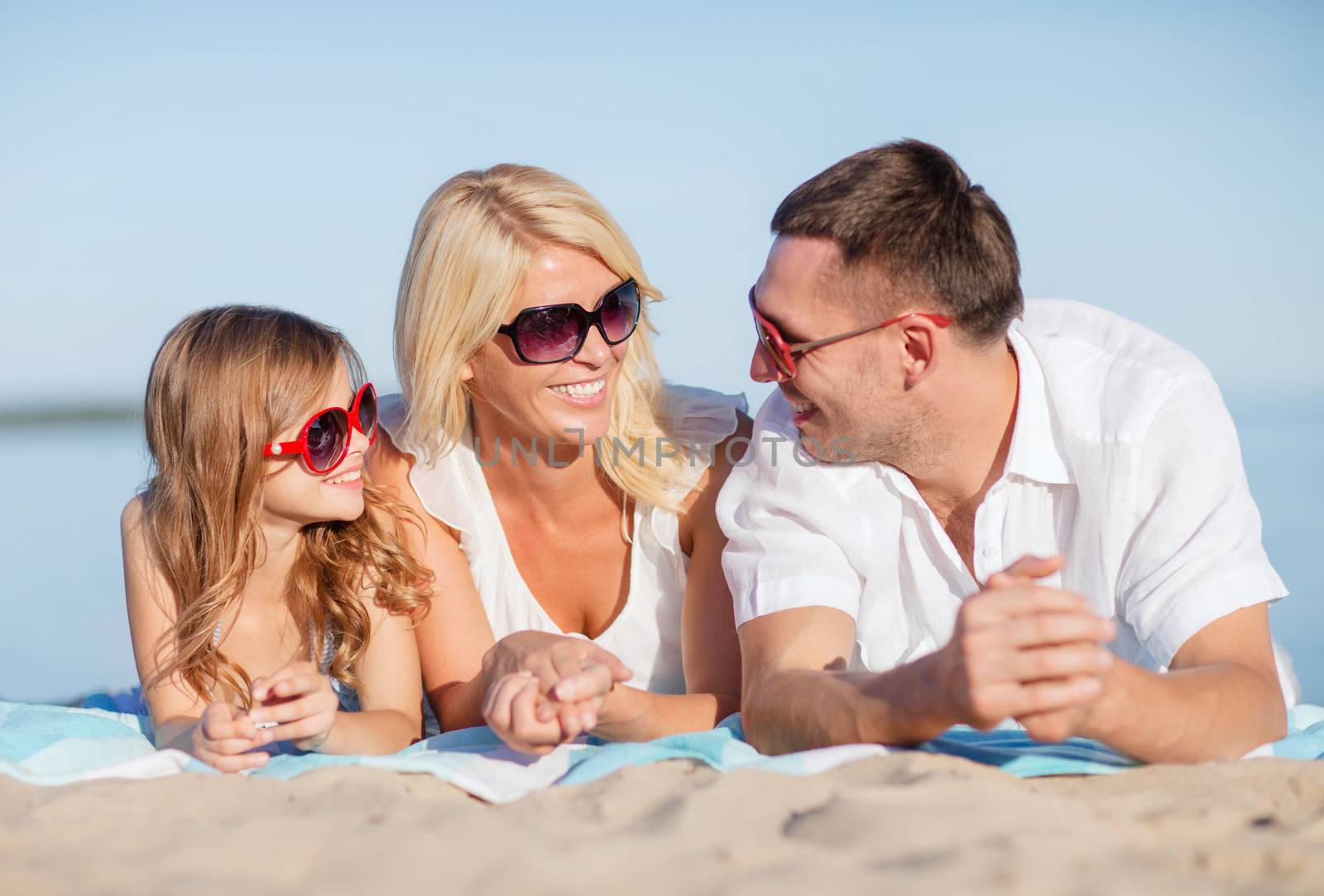happy family on the beach by dolgachov