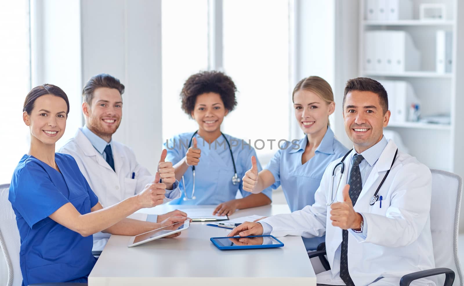 group of happy doctors meeting at hospital office by dolgachov