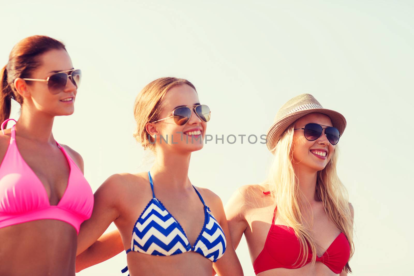 summer vacation, holidays, friendship and people concept - group of smiling young women in sunglasses