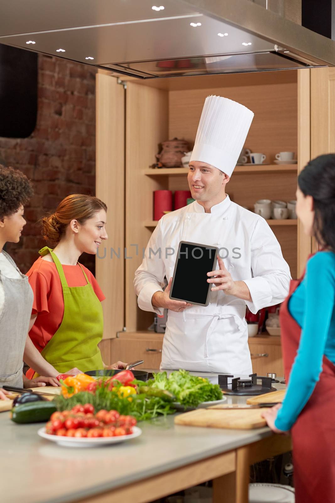 happy women with chef and tablet pc in kitchen by dolgachov