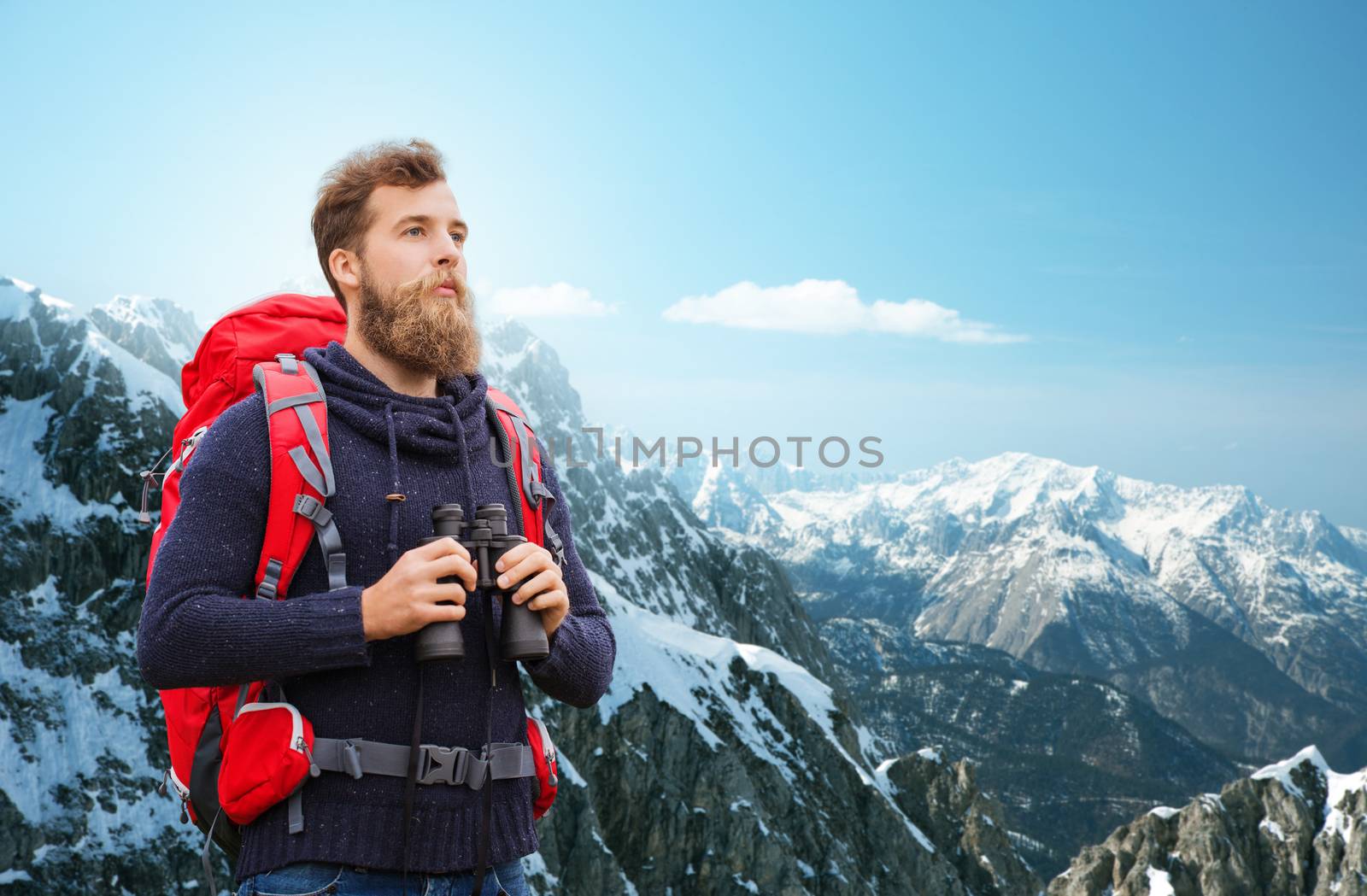 adventure, travel, tourism, hike and people concept - man with red backpack and binocular over alpine mountains background