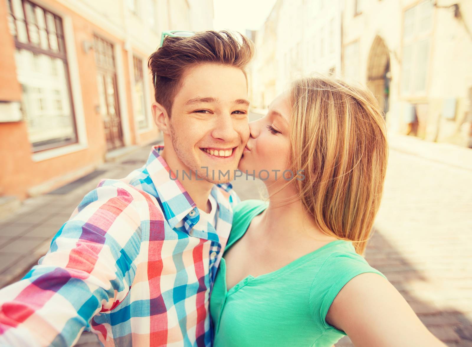 travel, vacation, technology and friendship concept - smiling couple with smartphone in city