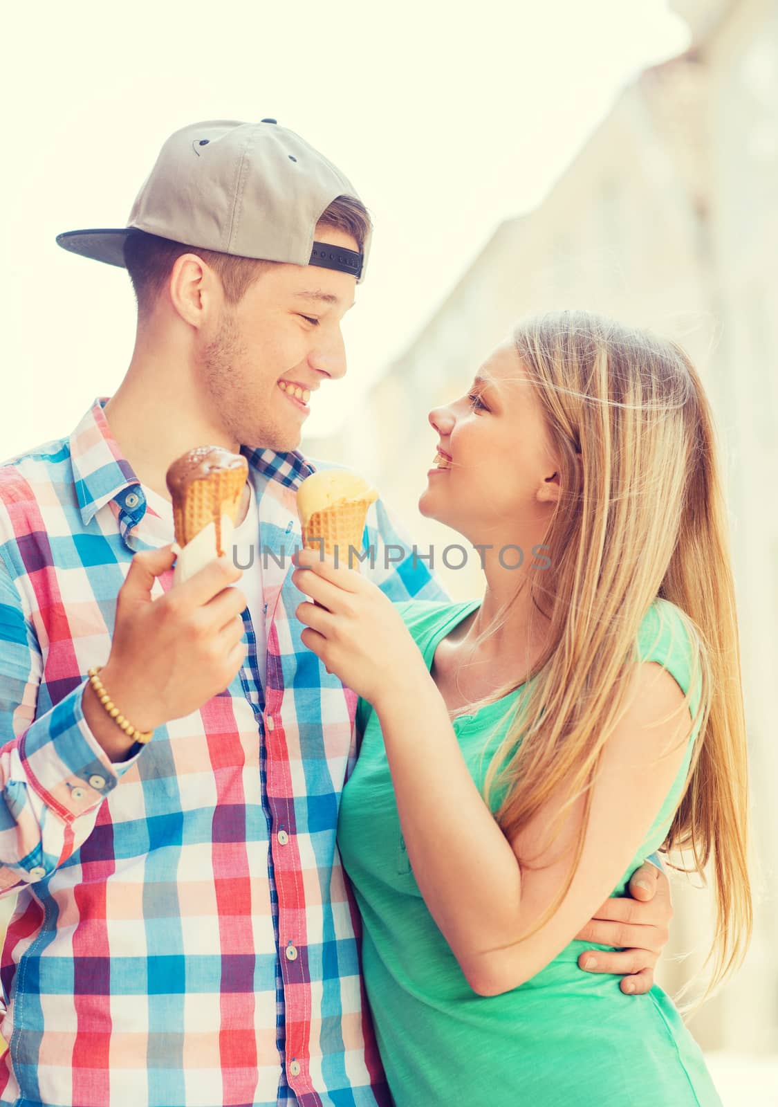 smiling couple with ice-cream in city by dolgachov