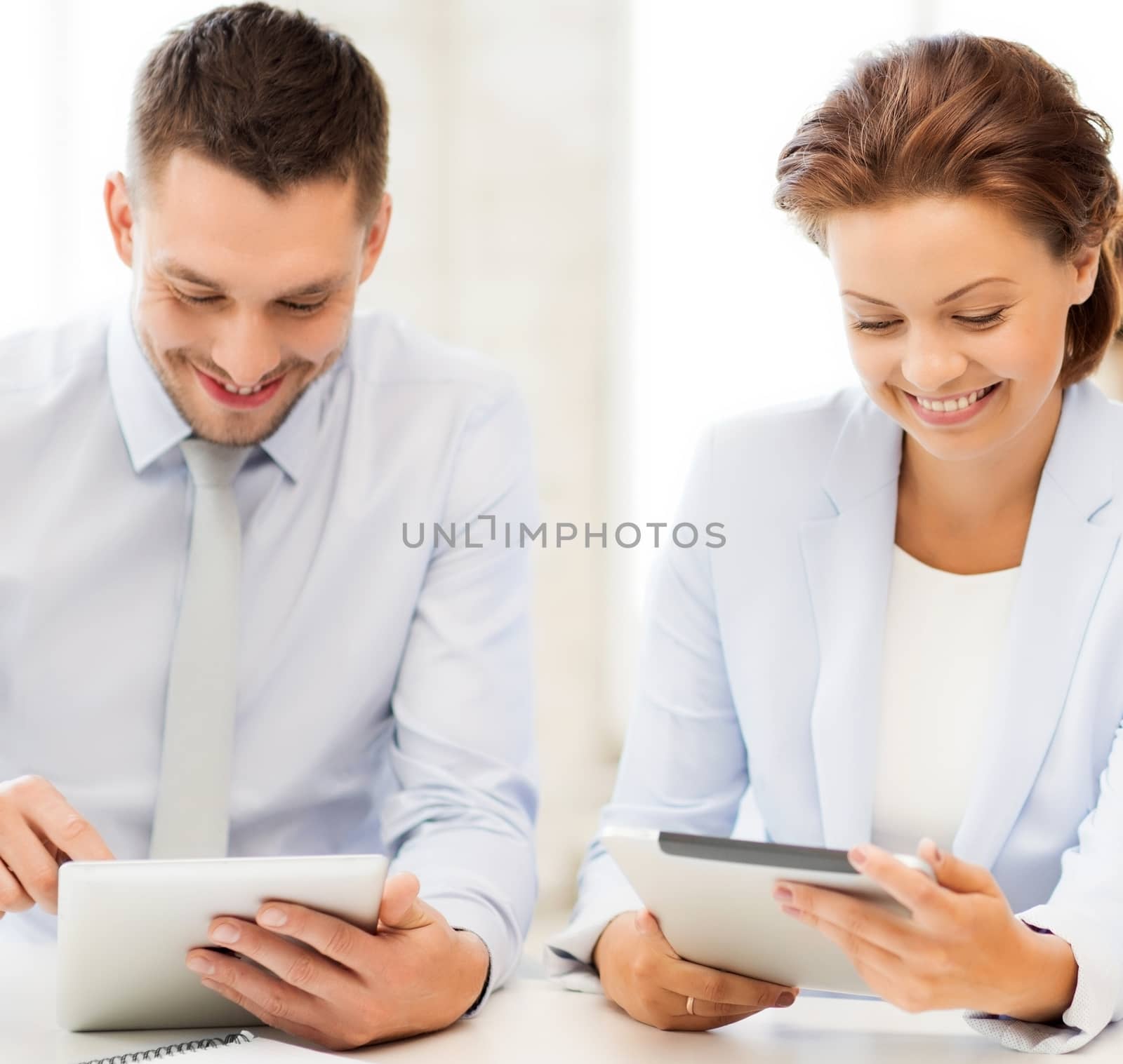 smiling business team working with tablet pcs in office