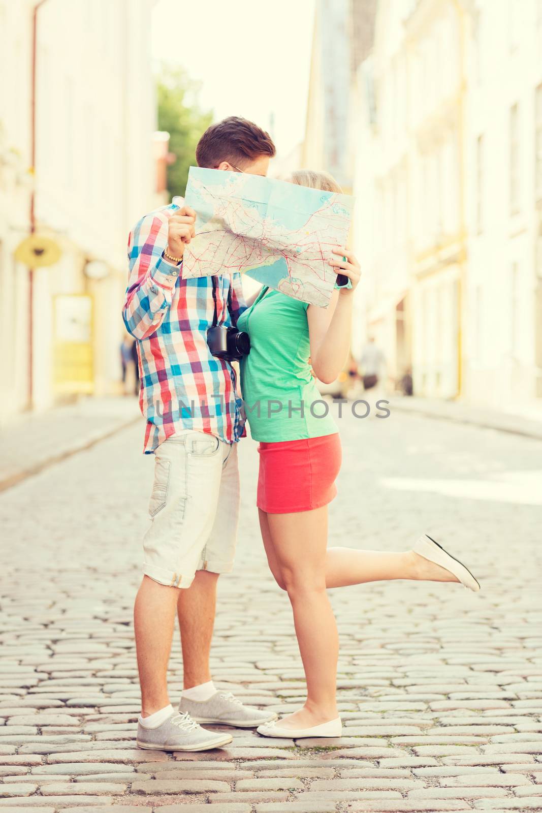 travel, vacation, technology and friendship concept - smiling couple with map and photo camera exploring city